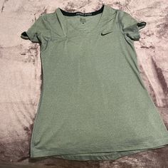 I Had Purchased This From The App Thread-Up (A Different Thrifting App) And Was Not True To Size. The Shirt Says Medium While If Fits Like Small. This Shirt Is Great For Sports Since It Is An Athletic Material. There's No Pilling, Stains, Or Tears. This Shirt Has Absolutely No Signs Of Being Worn. Almost Brand New. Nike Gray Stretch Top, Gray Nike Sports Top, Nike Gray Sports Top, Nike Casual V-neck Top, Nike Gray Sporty Top, Casual Stretch Nike T-shirt, Casual Nike Stretch T-shirt, Grey Nike Shorts, Tops Nike