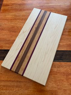 a wooden cutting board sitting on top of a hard wood floor