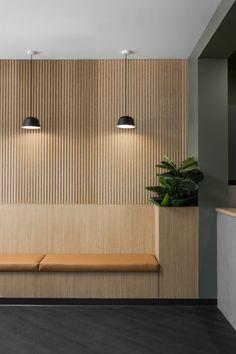 an empty bench in the middle of a room with wooden paneling on the walls