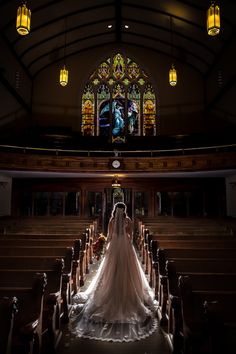 a bride and groom standing in front of the alter