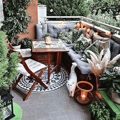 an outdoor seating area with potted plants and lights