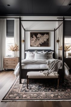 a bedroom with a four poster bed and wooden floors