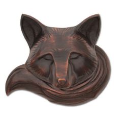 a metal wall hanging with a cat's head on it, and the face of a fox