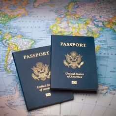 two passports sitting on top of a map