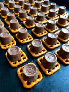 several pieces of chocolate sitting on top of plastic trays with holes in the middle