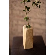 a wooden vase with flowers in it on a table