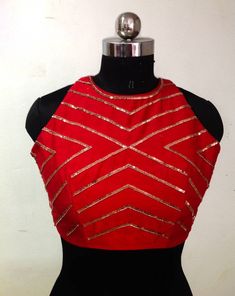 Red raw silk blouse with beautiful front and back geometric embroidery. The blouse will be made to order. You can specify the ready blouse size or you can share your custom measurements. I'll share a detailed measurement chart once you place the order. Matching saree listing: https://www.etsy.com/listing/939604188/copper-fern-leaf-sequin-embroidery-on Halter Neck Saree Blouse Front And Back, Red Blouse With Zari Work For Party, Red Party Blouse With Zari Work, Red Embellished Sleeveless Top, Red Mirror Work Top For Wedding, Red Wedding Top With Mirror Work, Red Fitted Sleeveless Blouse, Party Blouse In Red With Mirror Work, Red Party Blouse With Mirror Work