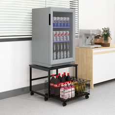 a beverage cooler sitting on top of a cart next to a counter filled with drinks