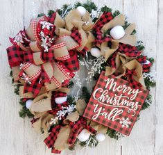 a christmas wreath on a white wooden surface