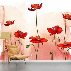 a room with red flowers painted on the wall and a chair in front of it