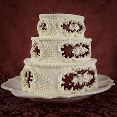 a three tiered wedding cake on a plate