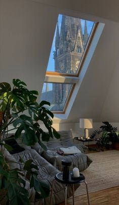 a living room filled with furniture and a skylight over the top of a building