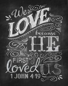 a chalkboard sign with the words we love because he first loved us and his name