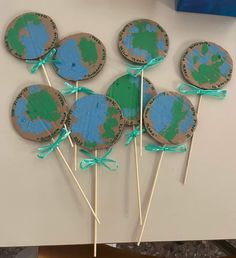 the earth lollipops are made to look like they have been painted green and blue