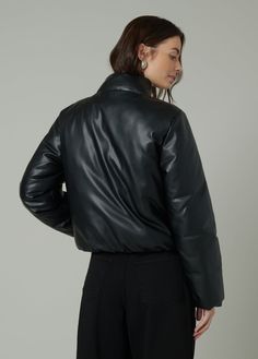 Slightly cropped jacket with a bubble hem that combines traditional styling and puffer detailing. DETAILS + FIT Slightly cropped fit Bubble hem Covered zip & snap closure Elastic hem & sleeve opening Soft vegan leather with added stretch for comfort. 100% Vegan leather with polyester backing Hand wash Turn the jacket inside out to protect the fabric from abrasion. Lay them flat in the sink or bathtub and rinse thoroughly with cold water to remove all suds. Spot clean when needed with a damp clot Fitted Cropped Leather Jacket For Winter, Cropped Leather Jacket For Winter Streetwear, Cropped Quilted Outerwear For Fall, Spring Cropped Puffer Jacket, Cropped Puffer Jacket For Spring, Puffy Outerwear For Streetwear In Fall, Casual Long Sleeve Puffer Leather Jacket, Quilted Cropped Jacket For Fall, Fall Puffy Outerwear For Streetwear