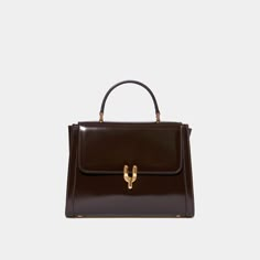 Dimensions : 23x17x6cm / 9x6.6x2.3inch50's inspired glossy calfskin bag with brass Diapason clasp. Created in collaboration with Laurence Fortin-Côté, this bag is inspired by her chic and vintage style. Can be carried by hand or on the shoulder with its adjustable leather shoulder strap. Made in Italy. My Style Bags, Timeless Chic, Purse Brands, Fancy Bags, Pretty Bags, Best Sneakers, Cute Bags, Suitcases, Small Leather Goods