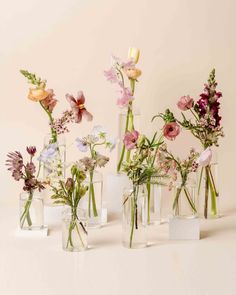 several glass vases with flowers in them