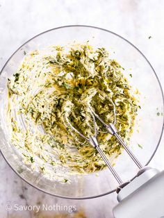 a glass bowl filled with spinach and cheese