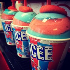 three ice cream cups with red, white and blue frosting on them are lined up