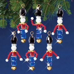 christmas ornaments hanging from a tree with blue and red decorations on it's sides