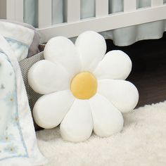 a large white flower sitting next to a crib