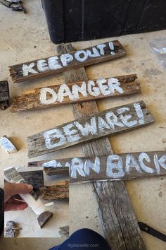 several wooden signs with words written on them