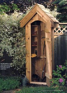 a garden shed with its door open and tools in the storage compartment on the outside