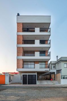 an apartment building with multiple balconies on the second floor