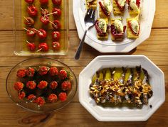 there are many different types of food on the plates and in bowls next to each other