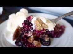 a close up of a plate of food with ice cream and berries on it,