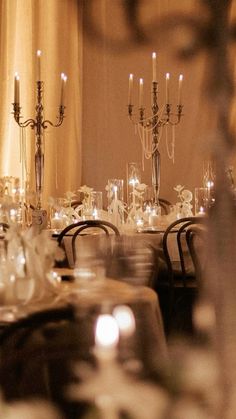 a long table with chairs and candles on it