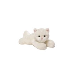 a white stuffed cat laying on top of a white floor next to a black and white wall