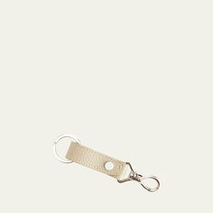 a white keychain with a metal hook on it's end and a leather strap around the clasp