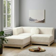 a living room with a white couch and coffee table