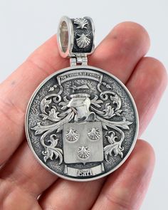 a person holding a silver medal in their hand