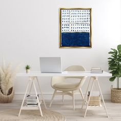 a white desk with a laptop computer on top of it next to a potted plant