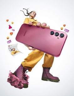 a person in yellow pants and purple boots holding a pink cell phone with buttons on it