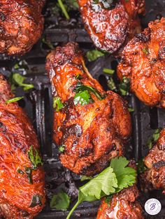 chicken wings on a grill with cilantro and parsley