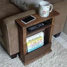 a coffee table with a cell phone on it and a book shelf next to it