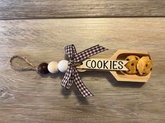 some cookies are in a box on a wooden table with a ribbon around the top