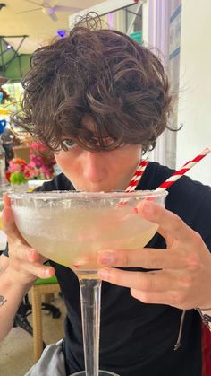 a woman holding a martini glass in front of her face