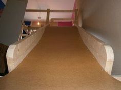 an empty room with carpeted stairs leading up to the second floor and another hallway in the background