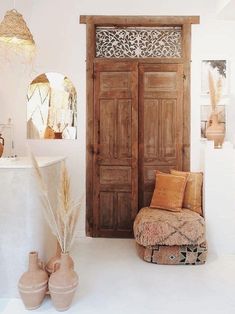 a living room filled with lots of furniture and decor on top of white flooring