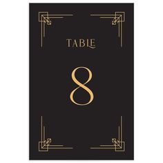 a black and gold table number 8 card with an art deco style frame on it