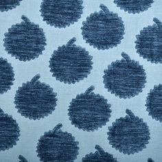 an upholstered blue and white fabric with small circles on the back of it