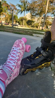 a person standing next to a pink skateboard