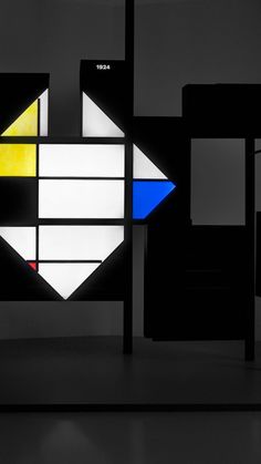 an abstract art piece is shown in black, white, and yellow colors on the wall