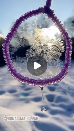 an image of the inside of a glass ornament with snow and trees in the background