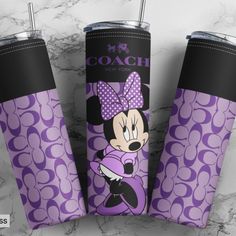 three purple minnie mouse tumblers on a marble counter with the name coach printed on them