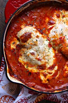 a skillet filled with chicken parmesan and sauce